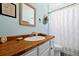 Bright bathroom featuring wood counters, a decorative shower curtain and modern fixtures at 8401 Secret Key Cv, Kissimmee, FL 34747