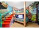 Themed bunk bedroom with colorful murals, a sturdy bunk bed, and whimsical decorations, creating a playful atmosphere at 8401 Secret Key Cv, Kissimmee, FL 34747