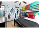 bedroom featuring colorful wall art, a bunk bed, ceiling fan, and wood floors at 8401 Secret Key Cv, Kissimmee, FL 34747