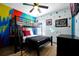 bedroom with fun wall art, a ceiling fan, and a black bunk bed at 8401 Secret Key Cv, Kissimmee, FL 34747