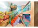 Themed bunk bedroom with colorful murals, a sturdy bunk bed, and whimsical decorations, creating a playful atmosphere at 8401 Secret Key Cv, Kissimmee, FL 34747