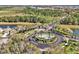 Aerial view of the community entrance with beautiful landscaping and a roundabout with a decorative fountain at 8401 Secret Key Cv, Kissimmee, FL 34747