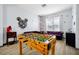 Game room features a foosball table, comfortable seating, and whimsical décor, offering endless entertainment options at 8401 Secret Key Cv, Kissimmee, FL 34747