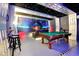 Spacious game room with a pool table, comfy couches, starry ceiling, and themed design, perfect for entertaining and relaxation at 8401 Secret Key Cv, Kissimmee, FL 34747