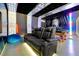 Comfortable game room featuring a sleek black leather couch, pool table, and immersive themed décor, ideal for entertainment at 8401 Secret Key Cv, Kissimmee, FL 34747