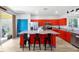 Modern kitchen featuring red cabinets, granite countertops, and a large center island with seating at 8401 Secret Key Cv, Kissimmee, FL 34747