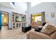 Bright, open living room featuring wood-look tile flooring, a large TV, and comfortable seating at 8401 Secret Key Cv, Kissimmee, FL 34747