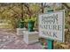 Inviting nature walk entrance marked by a decorative sign and potted plants at 8401 Secret Key Cv, Kissimmee, FL 34747
