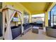 Screened patio area featuring a comfortable seating arrangement and stylish decor at 8401 Secret Key Cv, Kissimmee, FL 34747