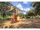 Colorful playground with a shaded canopy, climbing area, and swing set at 8401 Secret Key Cv, Kissimmee, FL 34747