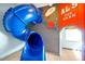 Unique playroom with a large blue slide and colorful space-themed wall decor at 8401 Secret Key Cv, Kissimmee, FL 34747