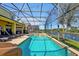 Enclosed pool with slide, water feature, and expansive views of the pond at 8401 Secret Key Cv, Kissimmee, FL 34747
