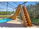 Poolside slide with water feature in a screened-in pool area at 8401 Secret Key Cv, Kissimmee, FL 34747