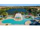 Aerial view of community pool, water park, lake and surrounding homes at 8936 Sydney Ave, Kissimmee, FL 34747