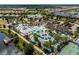 Bird's-eye view of the community's luxurious pool area, clubhouse, and lazy river amenities for leisure and recreation at 8936 Sydney Ave, Kissimmee, FL 34747
