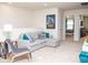 Cozy upstairs bonus room with gray sofa, accent pillows, and Guardians of the Galaxy poster at 8936 Sydney Ave, Kissimmee, FL 34747