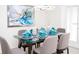 Dining room with a glass table, elegant decor and place settings, and modern lighting at 8936 Sydney Ave, Kissimmee, FL 34747