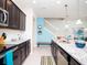 Modern kitchen with stainless steel appliances, dark wood cabinets, and an island with barstool seating at 8936 Sydney Ave, Kissimmee, FL 34747