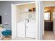Convenient laundry closet with washer, dryer, and shelving for storage at 8936 Sydney Ave, Kissimmee, FL 34747