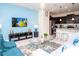 Inviting living room with a modern sofa, vibrant decor, and an open view to the kitchen area at 8936 Sydney Ave, Kissimmee, FL 34747