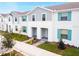 Stylish townhome exterior with gray siding and teal shutters at 8936 Sydney Ave, Kissimmee, FL 34747
