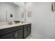 Elegant bathroom with dual sinks and stylish dark cabinets, offering modern convenience and a spa-like ambiance at 978 Splash Shot Pl, Davenport, FL 33896