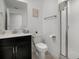 Clean bathroom featuring vanity with black cabinets, a tiled shower, and modern fixtures at 978 Splash Shot Pl, Davenport, FL 33896