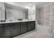 Modern bathroom featuring a double vanity, marble floors, and a shower-tub combination at 978 Splash Shot Pl, Davenport, FL 33896