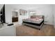 Bright bedroom featuring neutral decor, a comfortable bed, and an adjacent bathroom at 978 Splash Shot Pl, Davenport, FL 33896