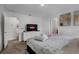 Cozy bedroom featuring a queen bed, soft lighting, a television, and easy access to an adjoining bathroom at 978 Splash Shot Pl, Davenport, FL 33896