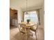 Charming breakfast nook with a round table, three chairs, and a window for natural light at 1010 Prey Ct, Kissimmee, FL 34746