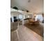 Open-concept dining room featuring a wooden table, chandelier, and view into the living area at 1010 Prey Ct, Kissimmee, FL 34746