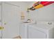 Functional laundry room with washer, dryer, storage shelf, and tiled flooring at 1010 Prey Ct, Kissimmee, FL 34746