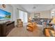 Inviting living room with plush carpet, comfortable seating, and a large TV for entertainment at 1010 Prey Ct, Kissimmee, FL 34746