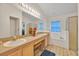 Main bathroom with double vanity, a separate tub and shower, and tile flooring at 1010 Prey Ct, Kissimmee, FL 34746