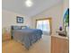 Main bedroom with high ceilings, carpet flooring, and large window at 1010 Prey Ct, Kissimmee, FL 34746