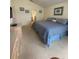 Main bedroom with ensuite bath featuring a large bed, neutral carpet, and ensuite bathroom entrance at 1010 Prey Ct, Kissimmee, FL 34746