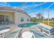 Inviting screened pool area with sun loungers, patio, and well-maintained landscaping at 1010 Prey Ct, Kissimmee, FL 34746