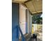 Back door of a blue home with a worn wooden porch and aged steps leading to backyard at 1011 26Th Street, Orlando, FL 32805