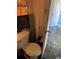 Compact bathroom showing a toilet, trash bin, and a partially open door at 1011 26Th Street, Orlando, FL 32805
