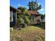 Exterior of a home with a brown-tone side with a small overgrown tree in the yard at 1011 26Th Street, Orlando, FL 32805