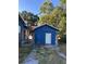 Blue detached garage or shed structure showing its exterior with a white door at 1011 26Th Street, Orlando, FL 32805