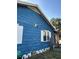 Blue home exterior featuring white shutters and trim around the windows at 1011 26Th Street, Orlando, FL 32805