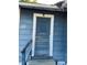 Weathered blue front door framed by white trim, showcasing the entry to this fixer-upper's potential at 1011 26Th Street, Orlando, FL 32805
