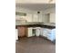 Depicts a kitchen with outdated cabinets, countertops, and linoleum flooring at 1011 26Th Street, Orlando, FL 32805