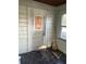 Sunroom featuring black tile, white walls, and a broom in the corner at 1011 26Th Street, Orlando, FL 32805