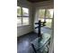 Sunroom with a glass table and two windows offering natural light and backyard view at 1011 26Th Street, Orlando, FL 32805