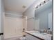 Bathroom features vanity, tub-shower combo with tile surround at 1017 Winding Water Way, Clermont, FL 34714