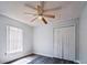 Bedroom with ceiling fan and a closet; bright natural light shines through window at 1017 Winding Water Way, Clermont, FL 34714