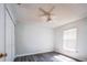 Bedroom with a ceiling fan, gray plank flooring and bright natural light at 1017 Winding Water Way, Clermont, FL 34714